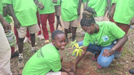Two students planting a tree